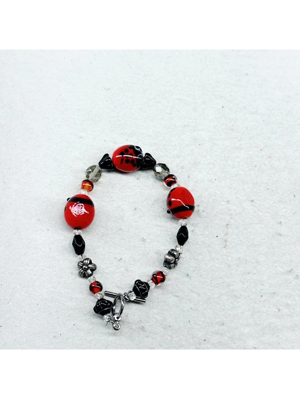 3011u. Silly Ladybug Glass Bracelet Silvertone